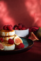 Cottage cheese pancakes with fresh raspberries on the table. Wallpaper, painting, desktop wallpaper.