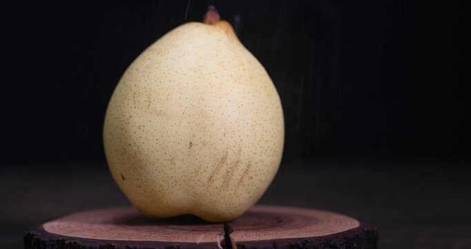 one ripe pear with a yellow tinge on the table, sweet fresh white pear in the kitchen