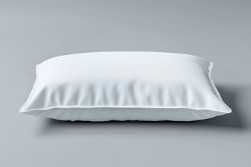 Soft White Pillow Resting on a Light Gray Surface in Simple Composition