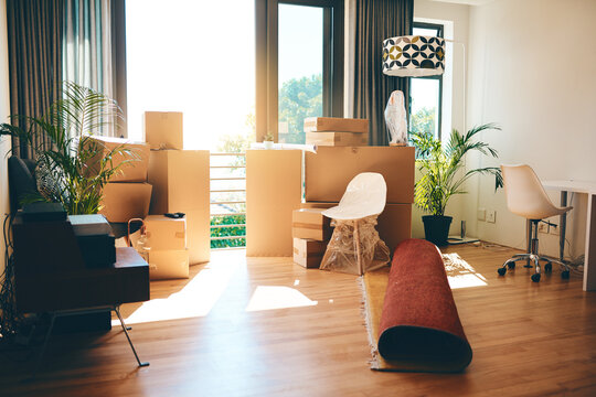 Boxes, furniture and empty home or modern apartment with property, mortgage or real estate background for moving in. Living room, lounge and new house with interior or space for relocation in USA