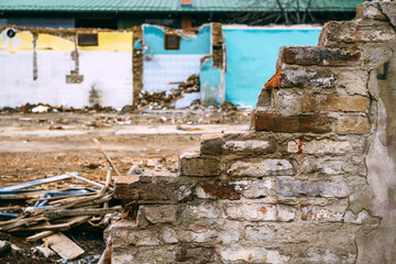 House demolition site, remains of an old brick wall of a run down building