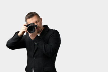 Man Taking Photo with Camera. A man using a camera, looking through the viewfinder
