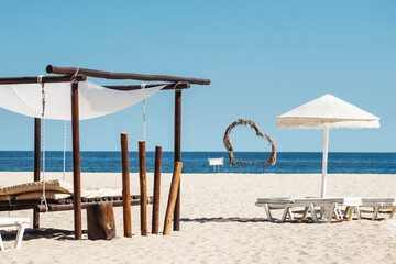 Holiday at sea. Sunbeds create a perfect summer retreat by the tranquil sea on a bright sunny day.