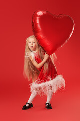 baby with heart balloon