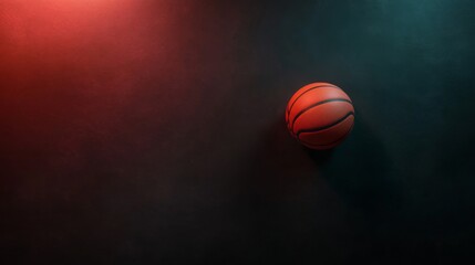 Fototapeta premium A single basketball rests on a textured dark surface with dramatic lighting creating shadows that enhance its features and texture, offering ample copy space