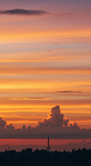 Fototapeta premium The fiery sunset creates a breathtaking display of colors across the expansive sky.