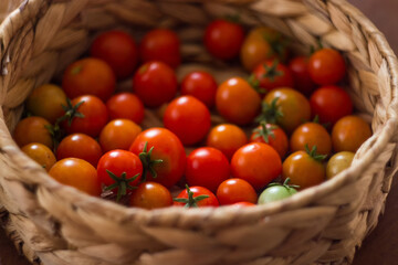 Ripe, tasty, red cherry tomatoes in a wooden basket