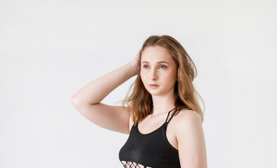 Fototapeta premium Portrait of a woman in a T-shirt on a light background.