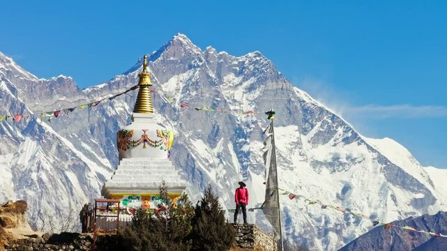 Majestic Mount Everest rising behind buddhist stupa, mountaineer gazing at panoramic himalayan landscape, capturing spiritual serenity and natural grandeur of Nepal