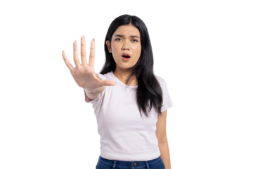 Young Asian woman showing stop gesture with hand, expressing refusal, disagreement, or warning, isolated on transparent background