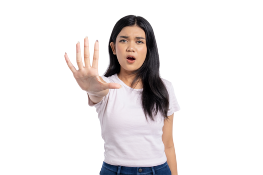 Young Asian woman showing stop gesture with hand, expressing refusal, disagreement, or warning, isolated on transparent background
