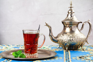 still life with traditional turkish tea in drinking glasses and silver traditional silver tea pot