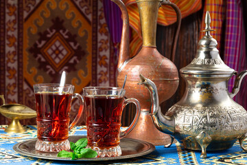still life with traditional turkish tea in drinking glasses and silver traditional silver tea pot