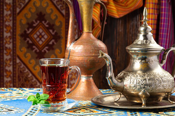still life with traditional turkish tea in drinking glasses and silver traditional silver tea pot