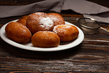 Berliner Pfannkuchen, a German donught dough  filled with chocolate cream and sprinkled with powdered sugar