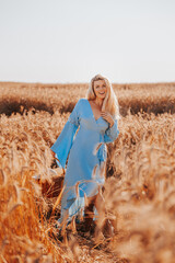 Charming blonde with natural beauty without plastic surgery against the background of a wheat field