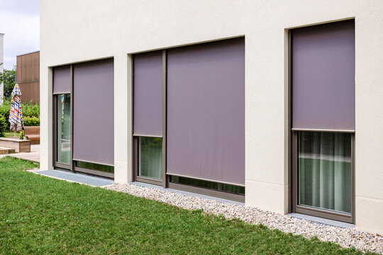 Blinds Outdoor. Modern Textile Roller Shutters on Large Windows. Screen Fabric Solar Blinds Outdoor. 