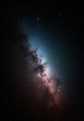 Obraz premium The Milky Way galaxy stretches across the night sky, filled with countless stars.