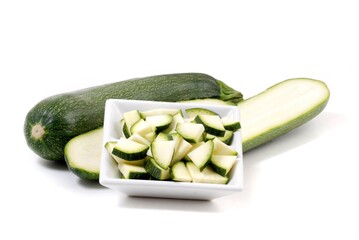 Zucchini. Fresh vegetables sliced on white background. Green courgette. 