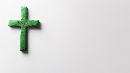 Obraz premium A green cross featuring subtle gradients stands on a bright white background, conveying themes of hope and faith in a calm, minimalist design
