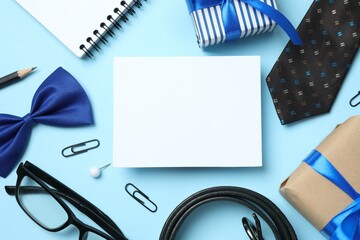 Father's Day concept. Top view photo of giftboxes with silk ribbon bow, glasses, belt and blue tie, on color blue background