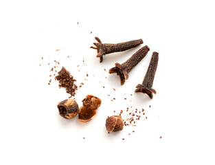 Clove spice crumbled isolated. Macro broken dry carnation spicy buds, natural Indian clove pieces