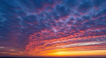 Obraz premium The beautiful sunset paints the sky with vibrant hues of orange, red, and purple.