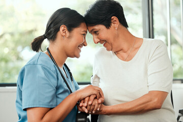 Holding hands, support and nurse with woman in wheelchair at assisted living facility for checkup....