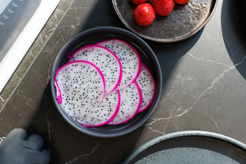 Dragon fruit slice on plate with pitahaya, fresh tropical fruit in healthy concept