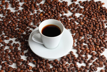 A Hot Cup of Coffee with Roasted Beans on a Clean White Backdrop