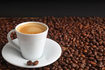 Elegant Espresso coffee in a White Cup with Dark Roasted Beans Around It