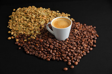 Cup of Coffee Surrounded by toasted and green Coffee Beans on Dark Background