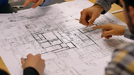 Blueprint Brainstorm: a group of skilled individuals collaborating intensely, engrossed in an architectural blueprint. They are working on plan with meticulous precision, focused on their design.