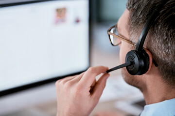 Customer service, call center and man with headset on computer for planning, online help and consulting. Corporate, telemarketing and person with microphone for contact, crm support and communication