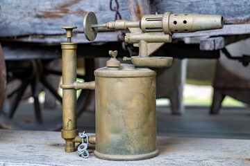 old gasoline soldering lamp used to heat up an element before soldering. relic. historical device.