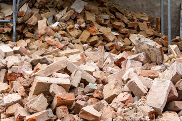 lying crumbled brick. demolition of an old red brick residential building in the city center. demolition of a residential building. ruin, a falling apart building.
