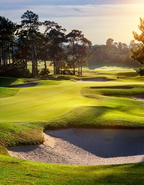 A scenic landscape featuring a lush green golf course with sand bunkers