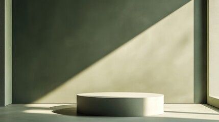 A sleek, monochromatic studio with a muted olive green backdrop, an empty podium, and natural light casting soft edges.