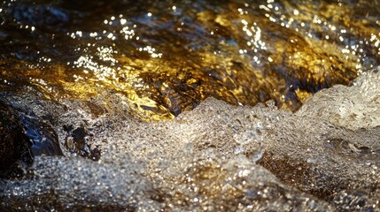 Clear water flowing and shimmering with bright reflections in sunlight