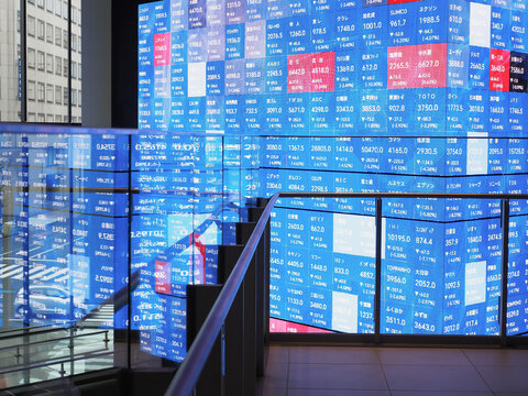 TOKYO, JAPAN - April 3, 2025: Screens on a block displaying Japanese company stock prices in Tokyo's Kabuto One building on the day when Trump's tariffs were announced and stock prices fell.