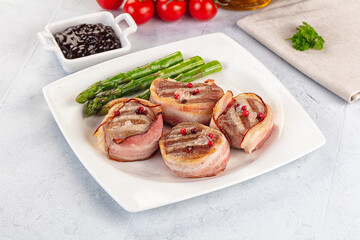 Tasty grilled pork medallion with bacon