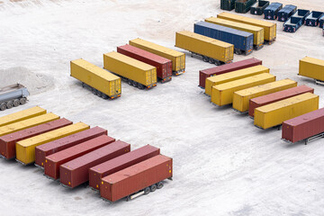 Colorful cargo containers organized in rows at a logistics hub, illustrating international freight shipping, trade and industrial infrastructure.
