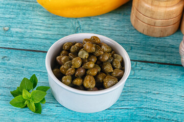 Pickled canned capers in the bowl