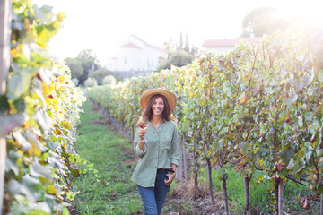 Tasting wine tour in vineyard. Woman with wineglass enjoying summer vacation. Beautiful country...