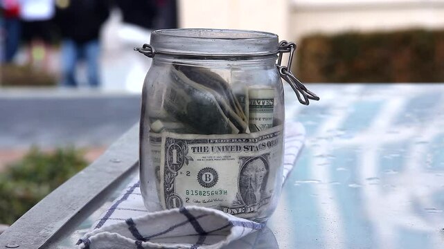 Glass Tip Jar On A Windy Day Outside