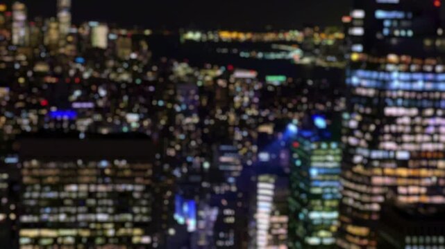 Blurred aerial view of New York lights at night creating strong bokeh effect. Ideal abstract background for urban mood, USA