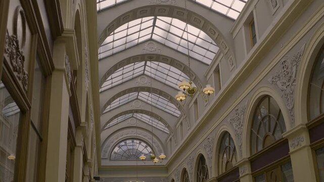 Classic Parisian glass-covered arcade with elegant architectural details and lighting