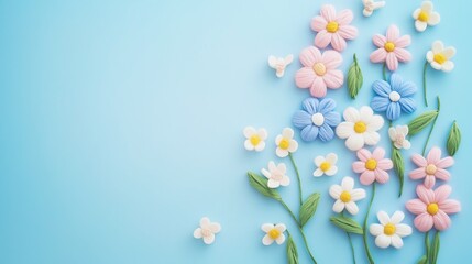 Obraz premium Colorful clay flowers on blue background with pink and white blossoms