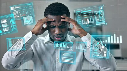 Stressed African American businessman with head in hands surrounded by digital graphs and data - Powered by Adobe