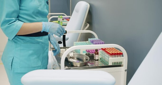 Clinic worker takes samples from a rack at a modern clinic. Equipment to take blood samples in the modern clinic.